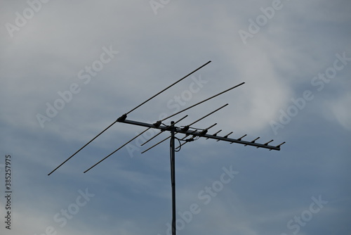 A simple TV antenna on a roof.