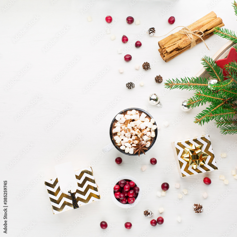 Obraz premium Christmas decoration, cup of coffee, homemade sweet gingerbread cookies, pine cones and branches on white wooden background.