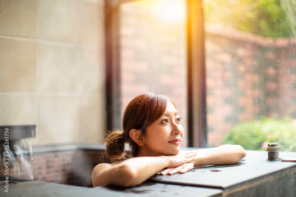 Asian Young woman relaxing in hot spring Asian Young woman relaxing in hot spring