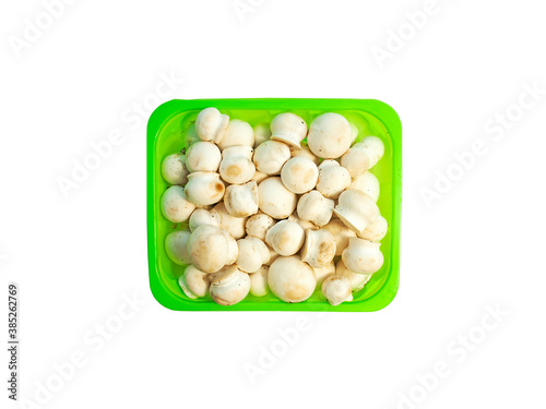 Fresh champignon mushrooms in a 
light green box.
Mini champignons isolated on a white background.