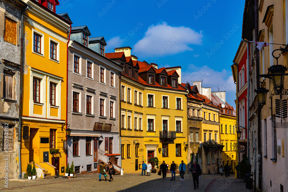 View of traditional colored tenements houses on central streets of Polish city of Lublin in sunny spring day - obrazy, fototapety, plakaty 