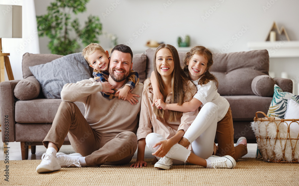 happy family mother father and children at home on couch . Stock Photo |  Adobe Stock