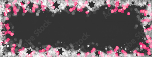 Christmas / winter background banner panorama template - Frame made of snow with snowflakes, stars and pink bokeh lights on black texture, top view with space for text © Corri Seizinger