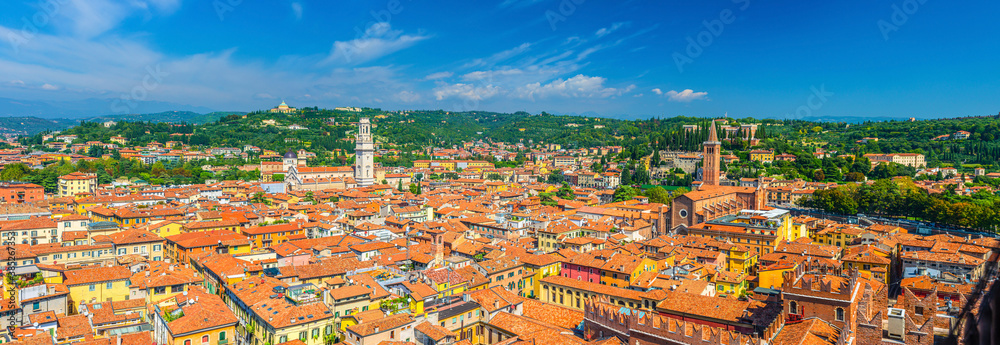 Aerial panoramic view of Verona city historical centre Citta Antica with red tiled roof buildings. Panorama of Verona town cityscape. Blue sky background copy space. Veneto Region, Northern Italy