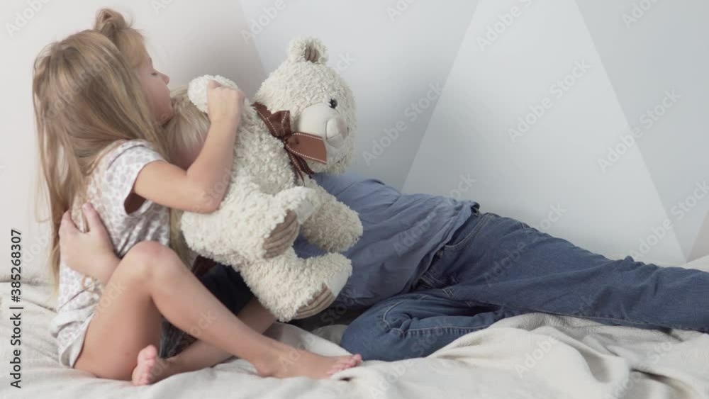 A cute brother and sister cuddle at home. A cute brother and sister cuddle at home.