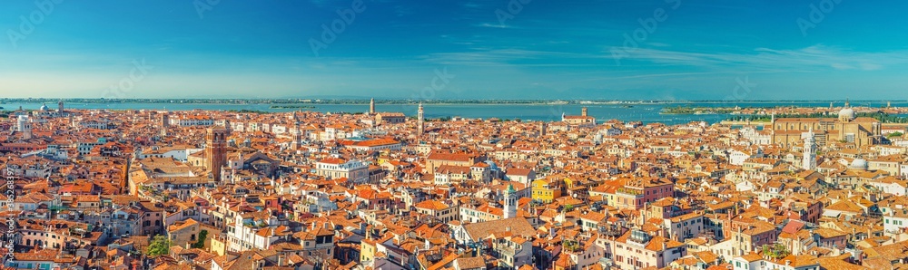 Aerial panoramic view of Venice city old historical city centre, buildings with red tiled roofs, San Giuliano Mestre and blue sky background, Veneto Region, Northern Italy. Amazing Venice cityscape.