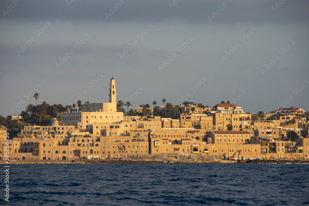 View at Old Jaffa buildings from the sea at twilight