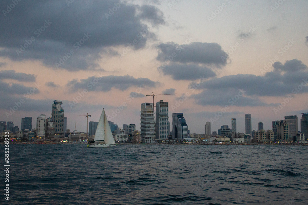 View at Tel Aviv buildings from the sea at twilight