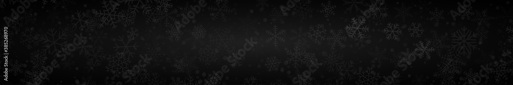 Christmas banner of snowflakes of different shapes, sizes and transparency on black background
