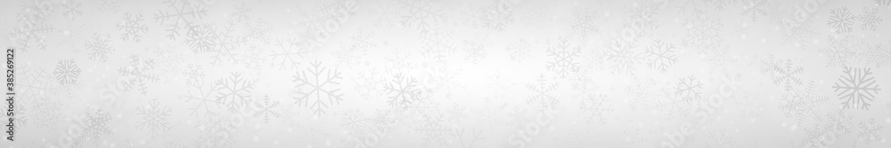 Christmas banner of snowflakes of different shapes, sizes and transparency on gray background Christmas banner of snowflakes of different shapes, sizes and transparency on gray background