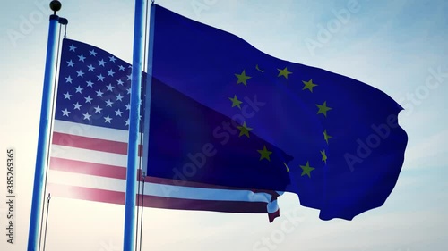United states and European union flags on a flagpole showing political relations. America and Europe joined by NATO and partnerships.