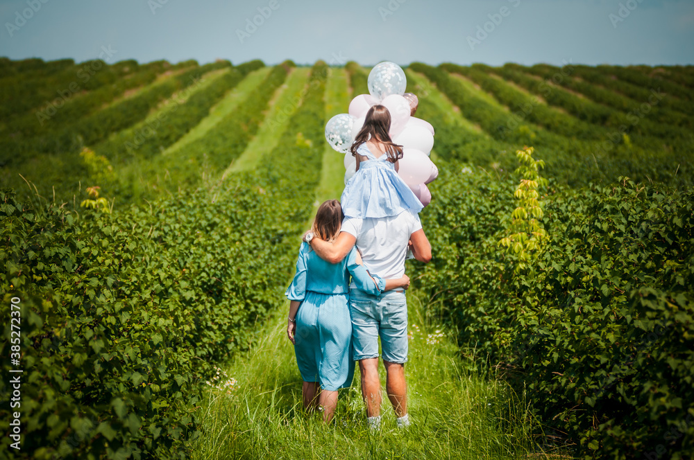 Fototapeta premium family walks in the currant garden