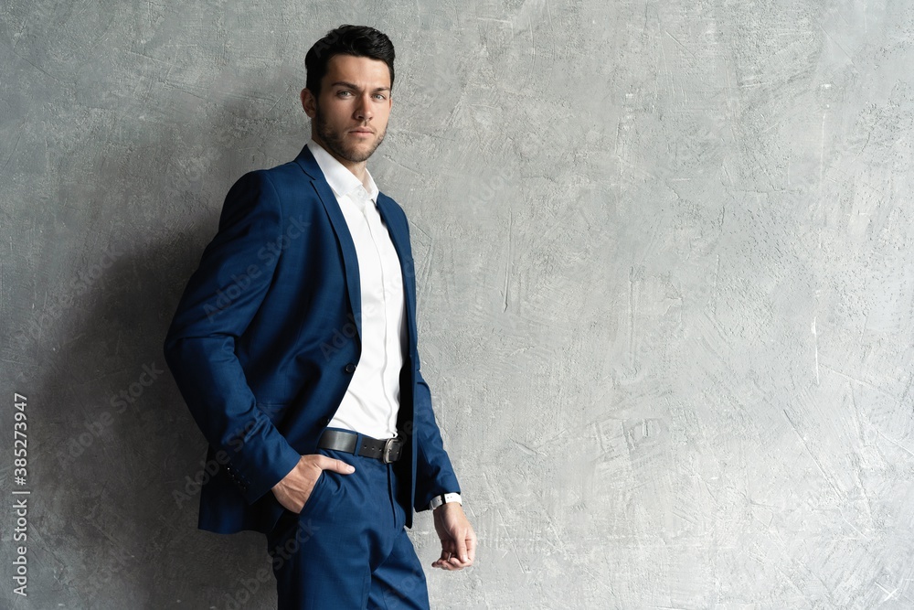 Handsome man wear blue suit isolated on grey background Handsome man wear blue suit isolated on grey background