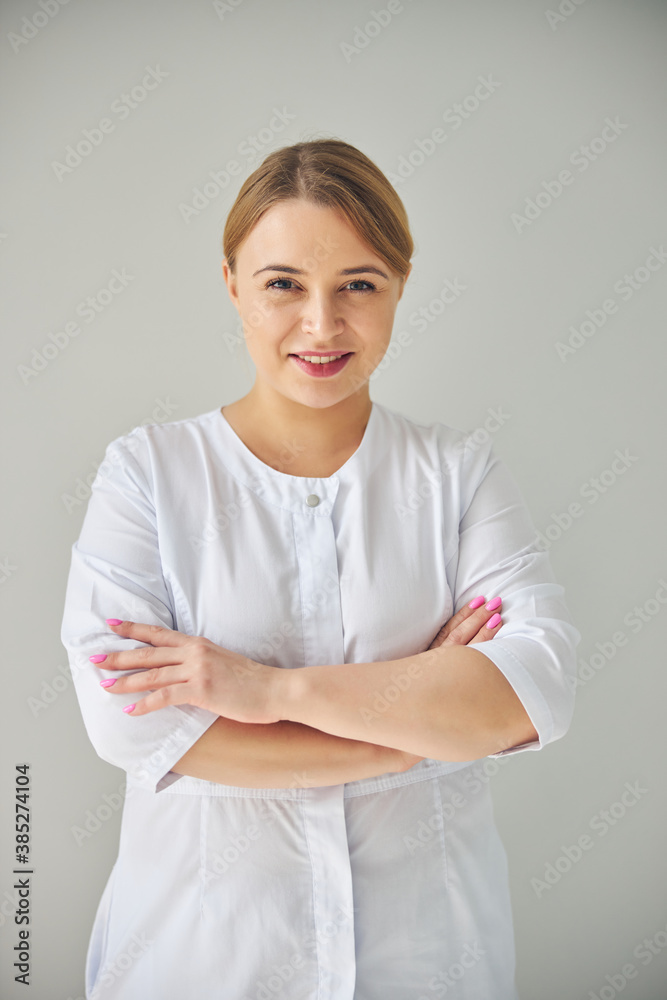 Female doctor with folded arms looking forward Female doctor with folded arms looking forward