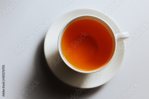Top view of a cup of hot tea with copy space.Hot tea is in a white glass placed on a white background. There is space for the message. White background.