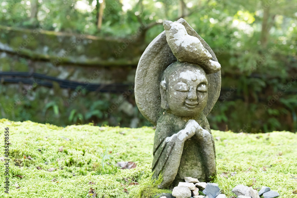 A small stone-built Jizo in a Japanese garden A small stone-built Jizo in a Japanese garden