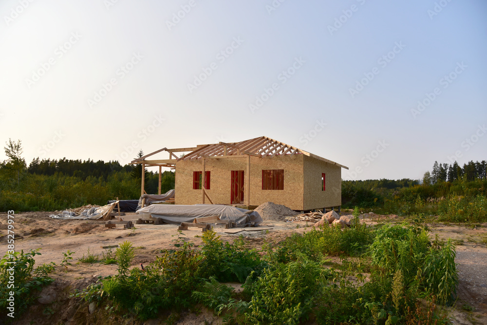 Construction wooden house of  Structural Insulated Panels (SIPs) turnkey ready project. Unfinished Wood residential building of panelized wall in country area. Sip house with timber frame