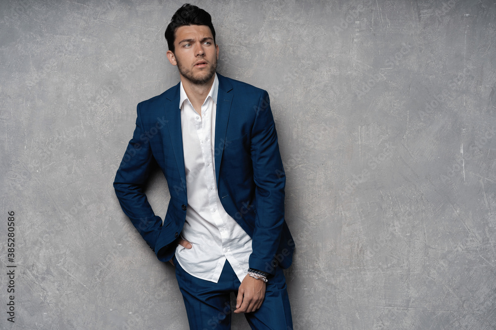 Handsome man wear blue suit isolated on grey background Handsome man wear blue suit isolated on grey background