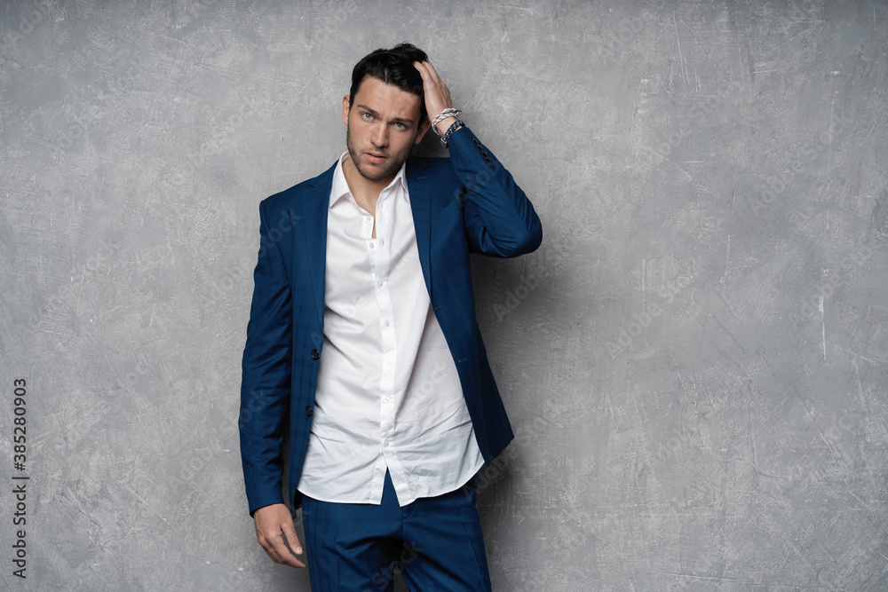 Handsome man wear blue suit isolated on grey background Handsome man wear blue suit isolated on grey background
