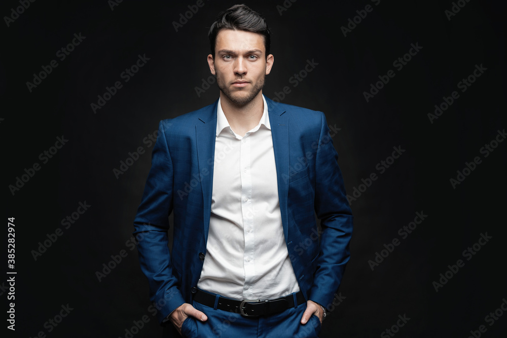 Handsome man wear blue suit isolated on black background Handsome man wear blue suit isolated on black background