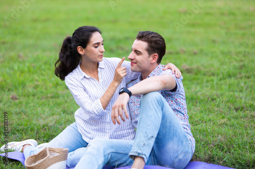 Romantic couple in love concept. Young happy couple enjoying picnic at the park on a holiday.