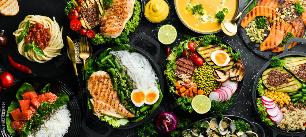 Food background: pasta, chicken, pumpkin, salad, meat, mushrooms, vegetables. On a black stone background. Top view. Free space for text. - obrazy, fototapety, plakaty 