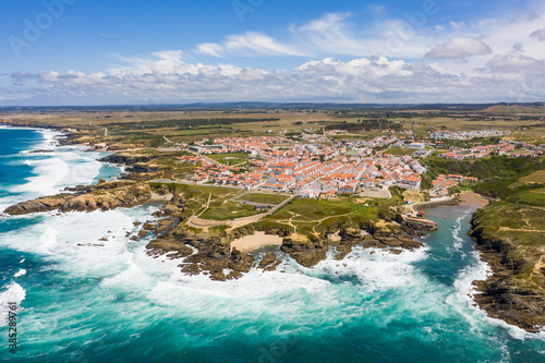 Aerial view of Porto Covo and waves crashing onto rocks, Setubal, Portugal.