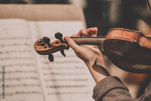 Close frame for the hand of a violinist of a symphony orchestra