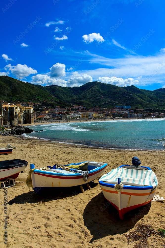 Cefalu city beach with wooden fishing boats