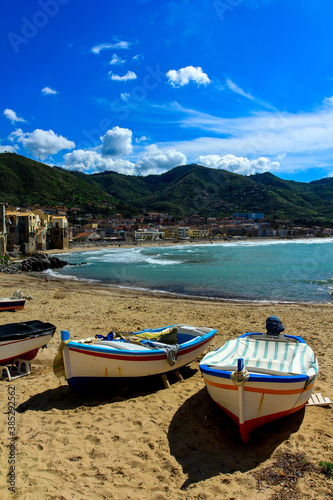 Cefalu city beach with wooden fishing boats