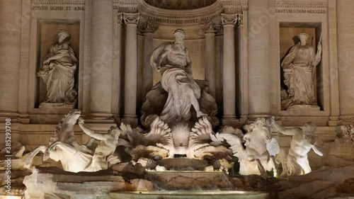 Trevi Fountain (Italian: Fontana di Trevi) at night in Rome, Italy, city landmark from 1762, one of the most famous Baroque fountains in the world, zoom out in 4k.