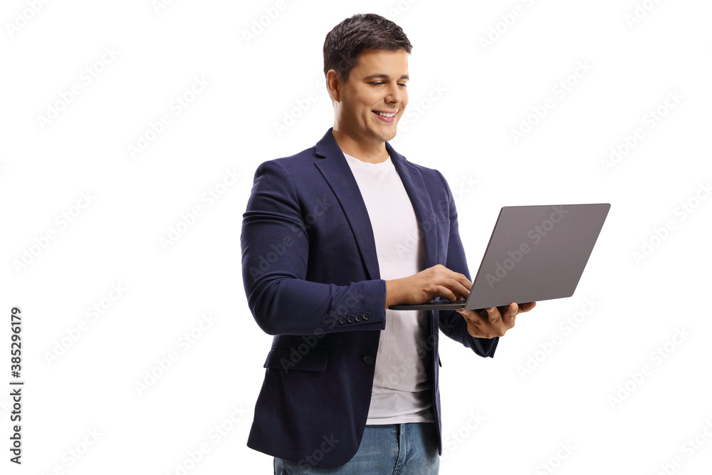Young man standing and looking in a laptop computer Young man standing and looking in a laptop computer