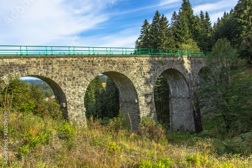 View of stone Railway Viaduct in a small village of Pernink, Czech republic. Old Czech railway line. Vintage arch bridge.