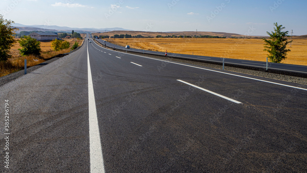 newly built asphalt road highway and vehicles long asphalt road,