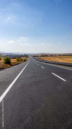 newly built asphalt road highway and vehicles long asphalt road 