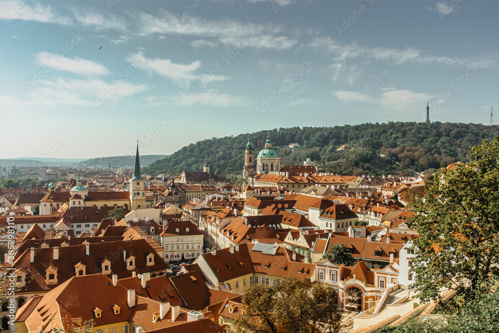 Aerial view of old town with hictorical buildings,red roofs,churches,Petrin hill in Prague,Czechia.Prague panorama.Beautiful sunny landscape of the capital of Czechia.Amazing European cityscape.