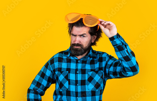 looking so trendy. need some fun. serious brutal party goer. mature bearded hipster. fashion concept. trendy man in funny party glasses. funny and serious man wear checkered shirt