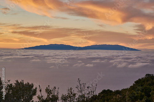 Beautiful sunset in La Gomera with view on el Hierro. Sunset above the atlantic ocean with view on an island. © loopzn