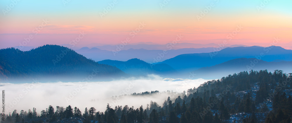 Beautiful landscape with cascade blue mountains at the morning - View of wilderness mountains during foggy weather Beautiful landscape with cascade blue mountains at the morning - View of wilderness mountains during foggy weather