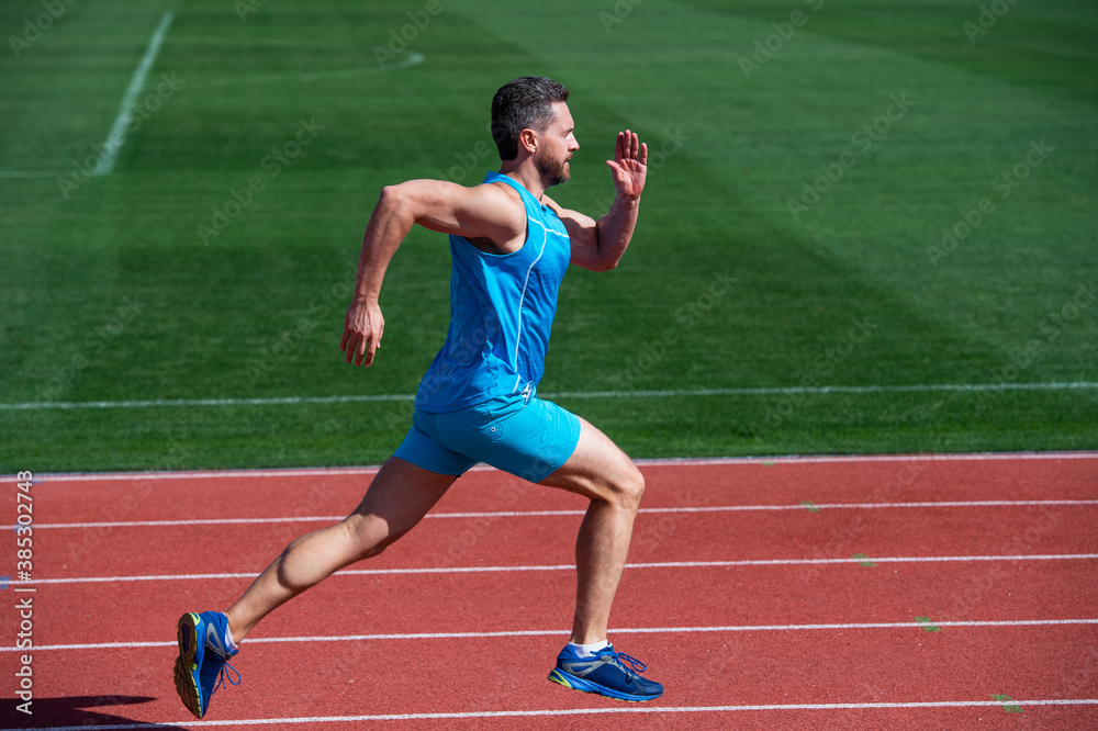 Fototapeta premium Great progress. muscular guy run to success. man running on stadium. sports healthy lifestyle routine. sport workout. male athlete do morning exercise. sportsman runner outdoor. health care. energy