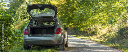 wide shot of car with open trunk parked on a mountain road near the Italian national park of Abruzzo,Lazio and Molise photo