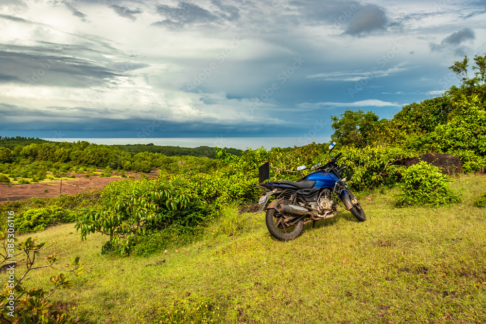 Fototapeta premium motorcycle at mountain top with amazing blue sky at morning
