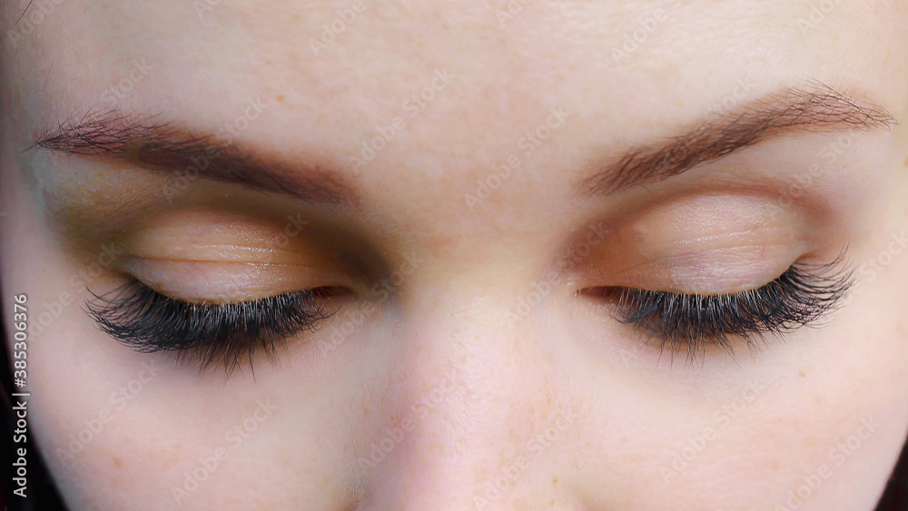 Obraz premium Concept of beauty and fashion. Banner women's eyes with long false eyelashes. Macro snapshot.