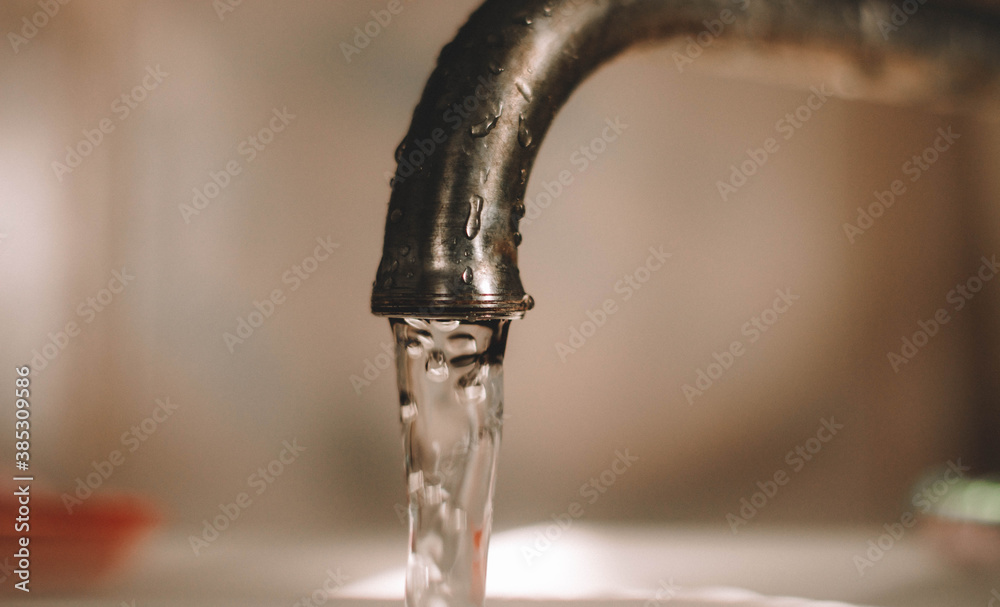 water pours from the tap water pours from the tap