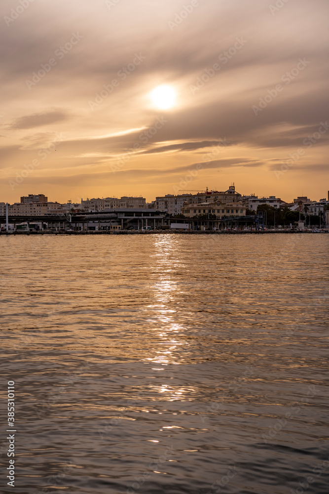 sun reflecting on the water with the city in the background