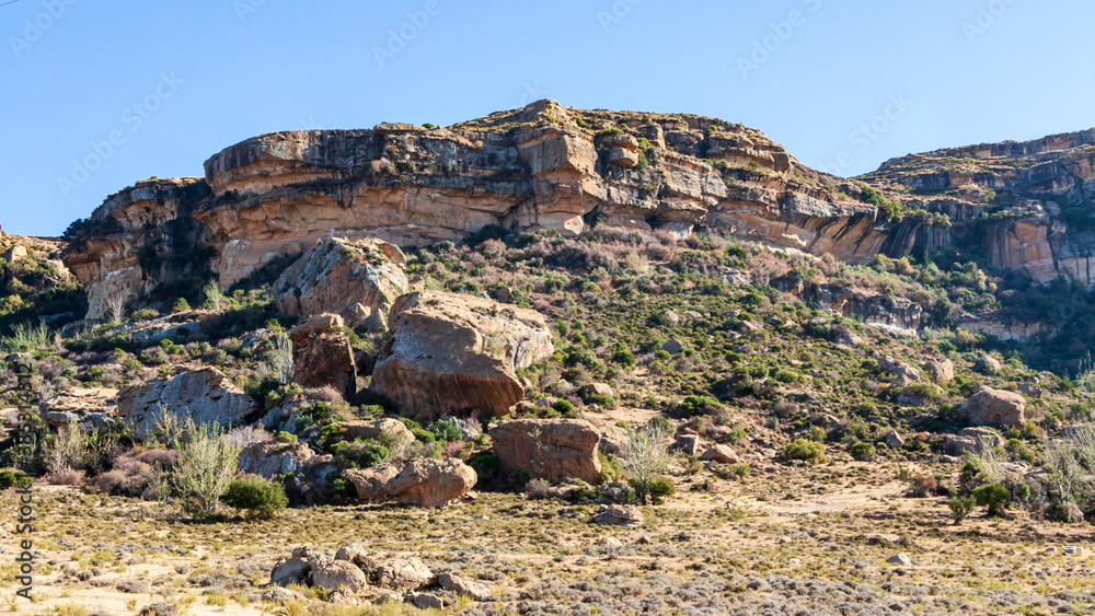 Close to Maseru, the capital city of Lesotho, is a big mountain plateau. Looking up at it reveals beautiful red and white sandstone rocks.