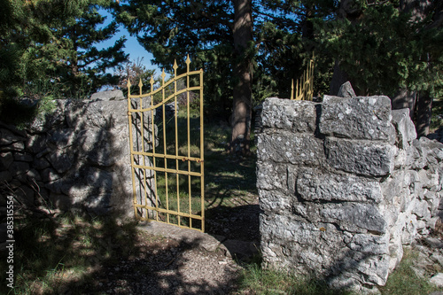 SEGET GORNJI, CROATIA, June 2020. - Church of St. Elijah on Sutilija hill near Trogir. Stone enclosure around the church and metal fence photo