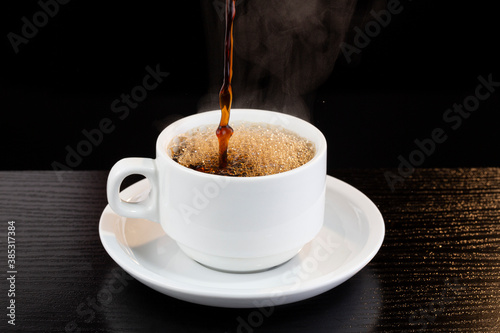 Hot black coffee being served in a cup