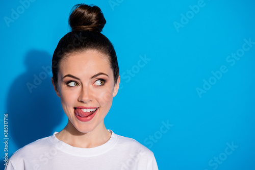 Close-up portrait of her she nice attractive pretty lovely cute girlish funky playful cheerful cheery girl licking lip counting calories isolated on bright vivid sine vibrant blue color background