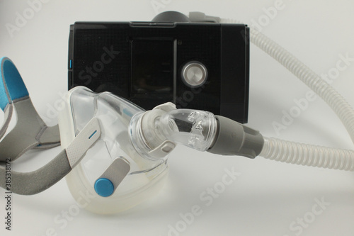 CPAP machine with adult full face mask for the treatment of sleep apnoea, isolated on a white background